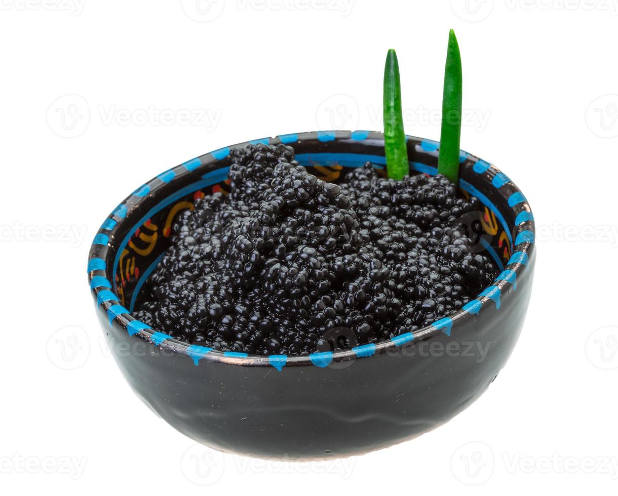 Black caviar in a bowl on white background photo