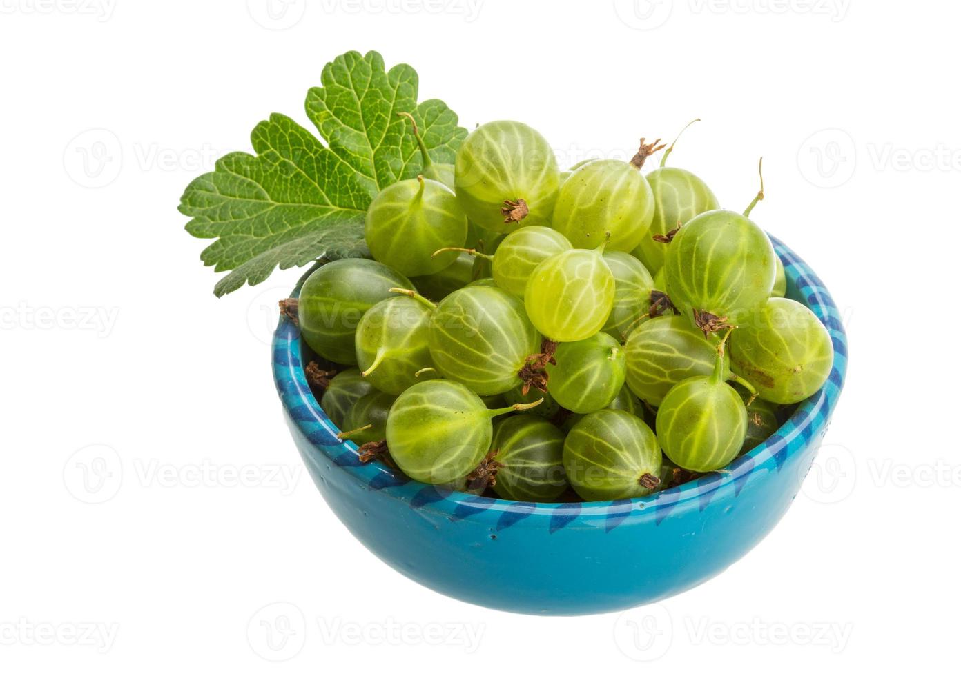 Gooseberries in a bowl on white background photo