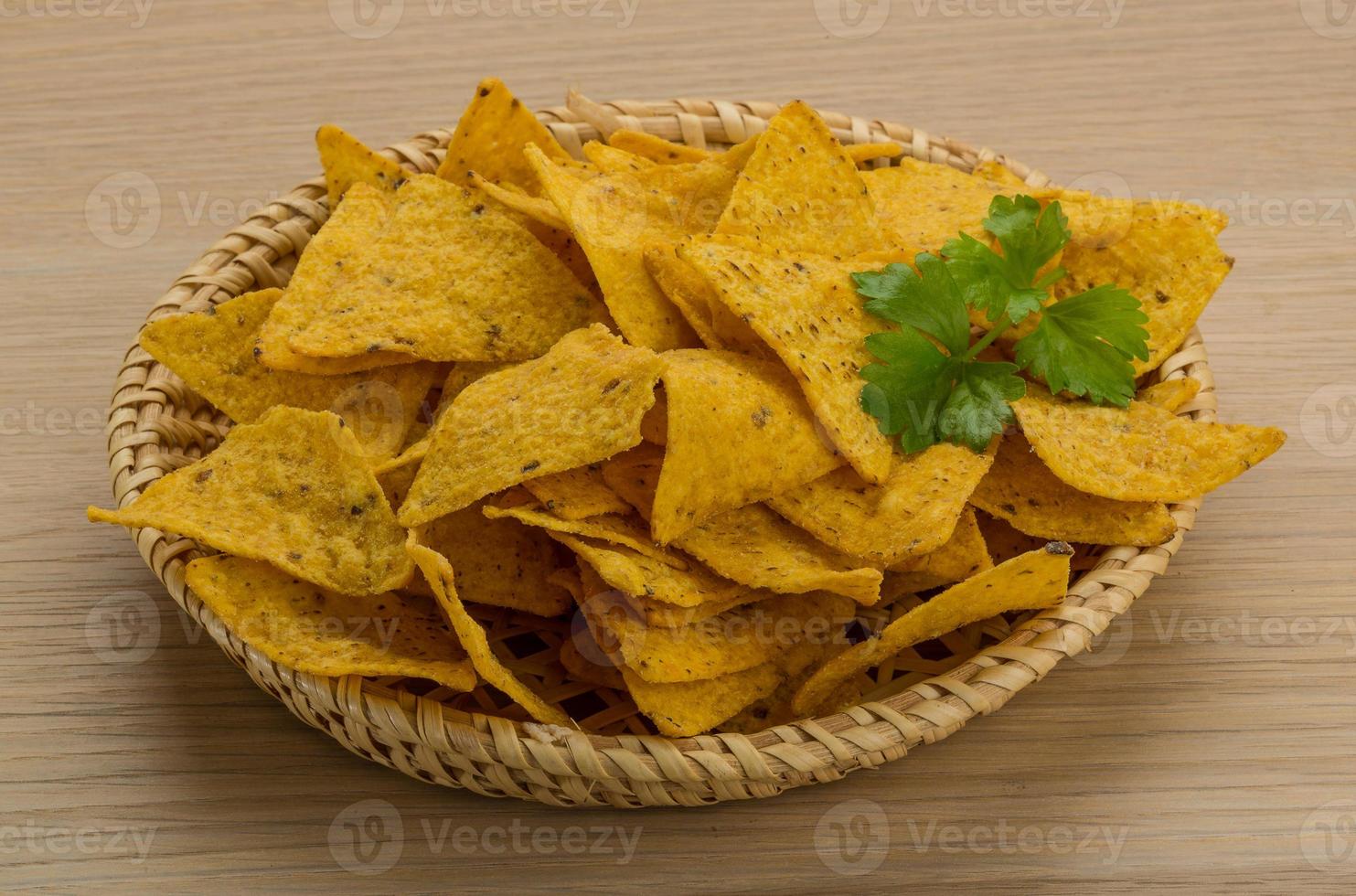 Nachos in a basket on wooden background 10861701 Stock Photo at Vecteezy