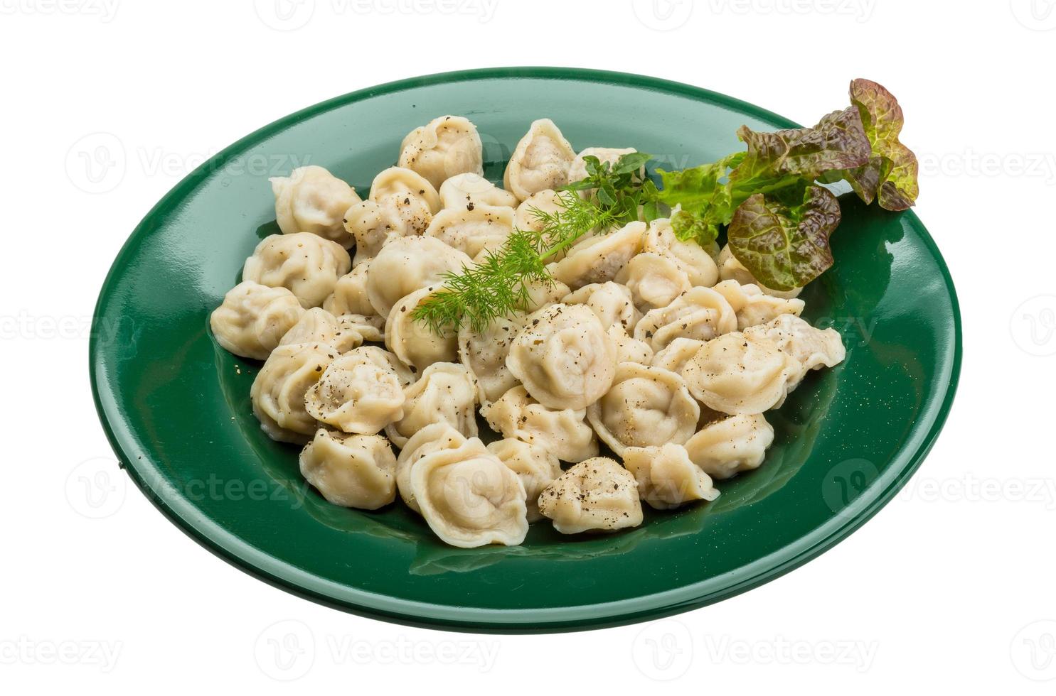 Russian dumplings on the plate and white background photo