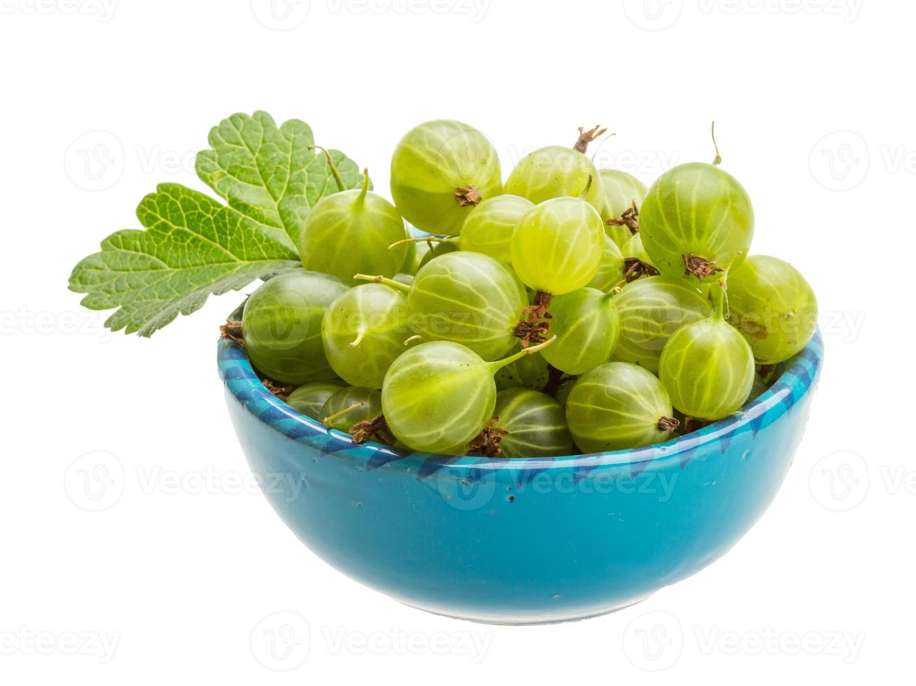 Gooseberries in a bowl on white background photo