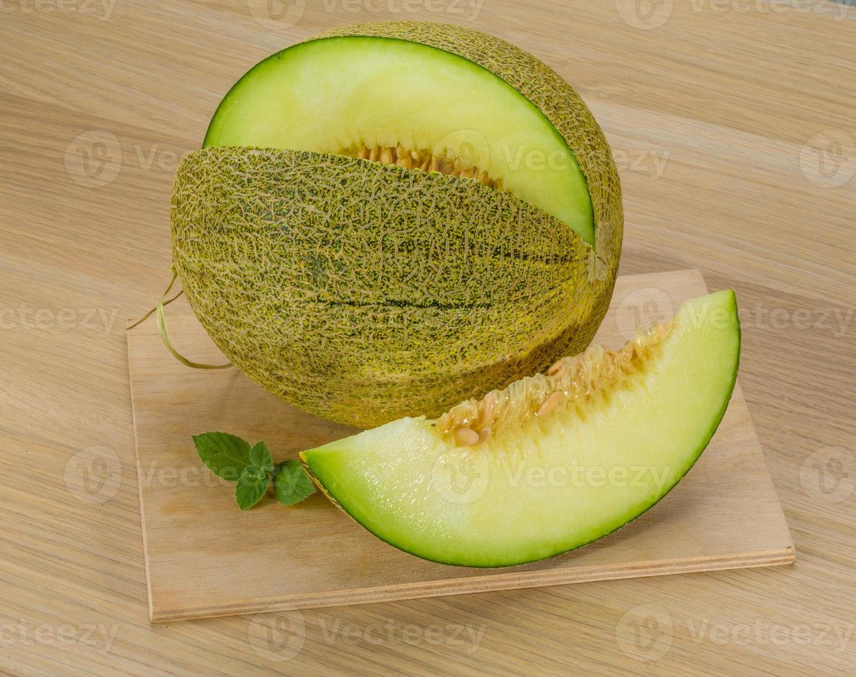 Melon on wooden background photo