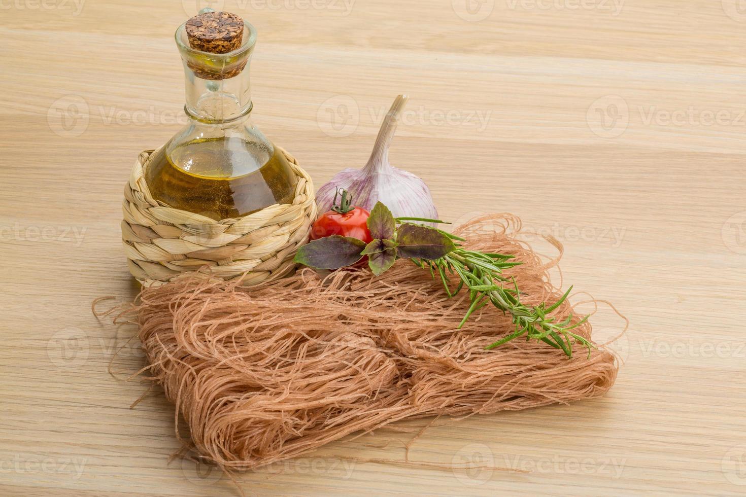 Raw soba on wooden background photo