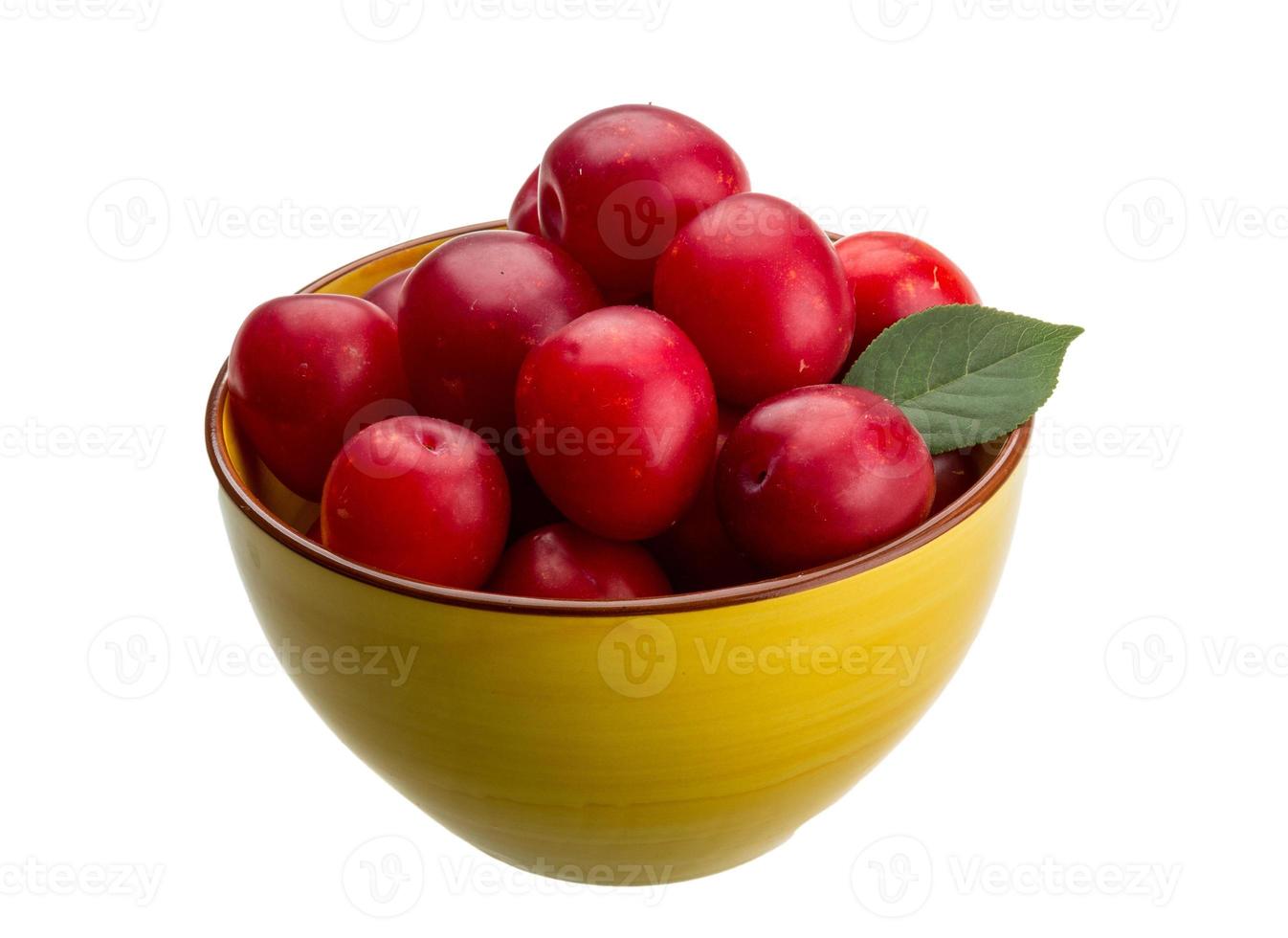 Damson plum in a bowl on white background photo