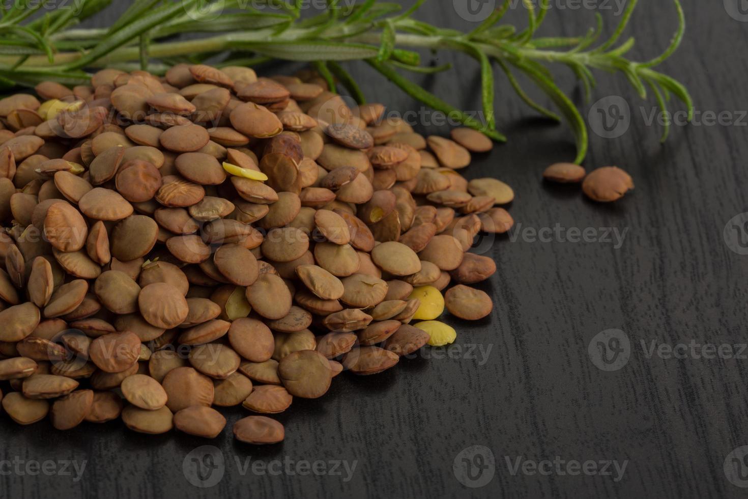 Raw lentils on wooden background photo