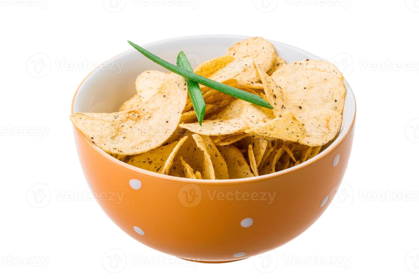 Potato chips in a bowl on white background photo