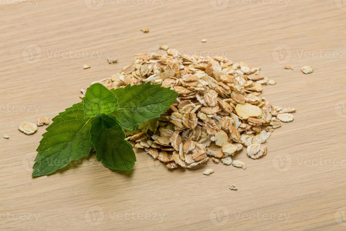 Oats on wooden background photo