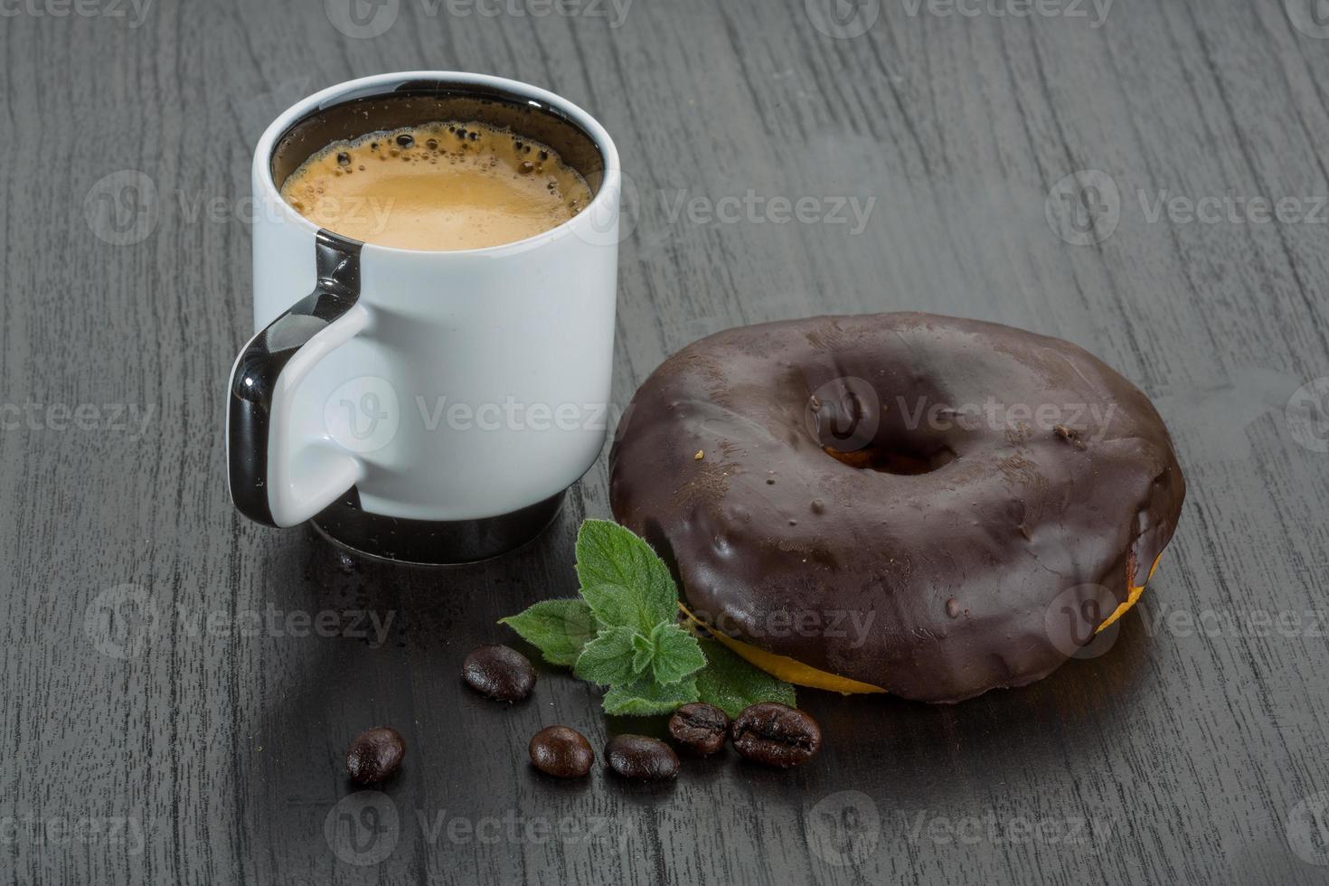 Coffee with donuts on wooden background photo