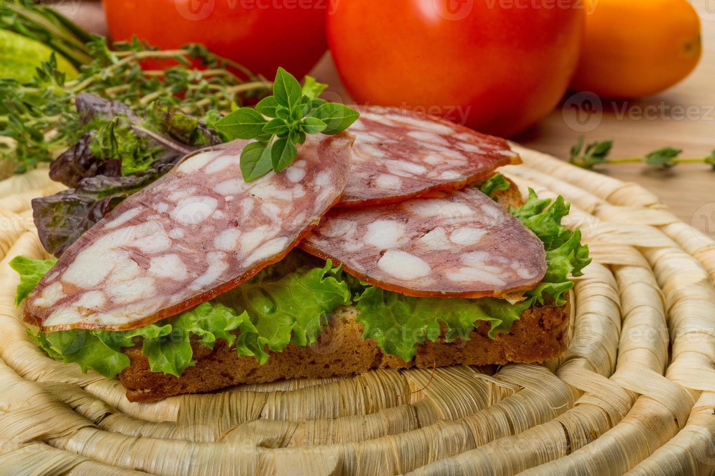 Salami on wooden plate photo