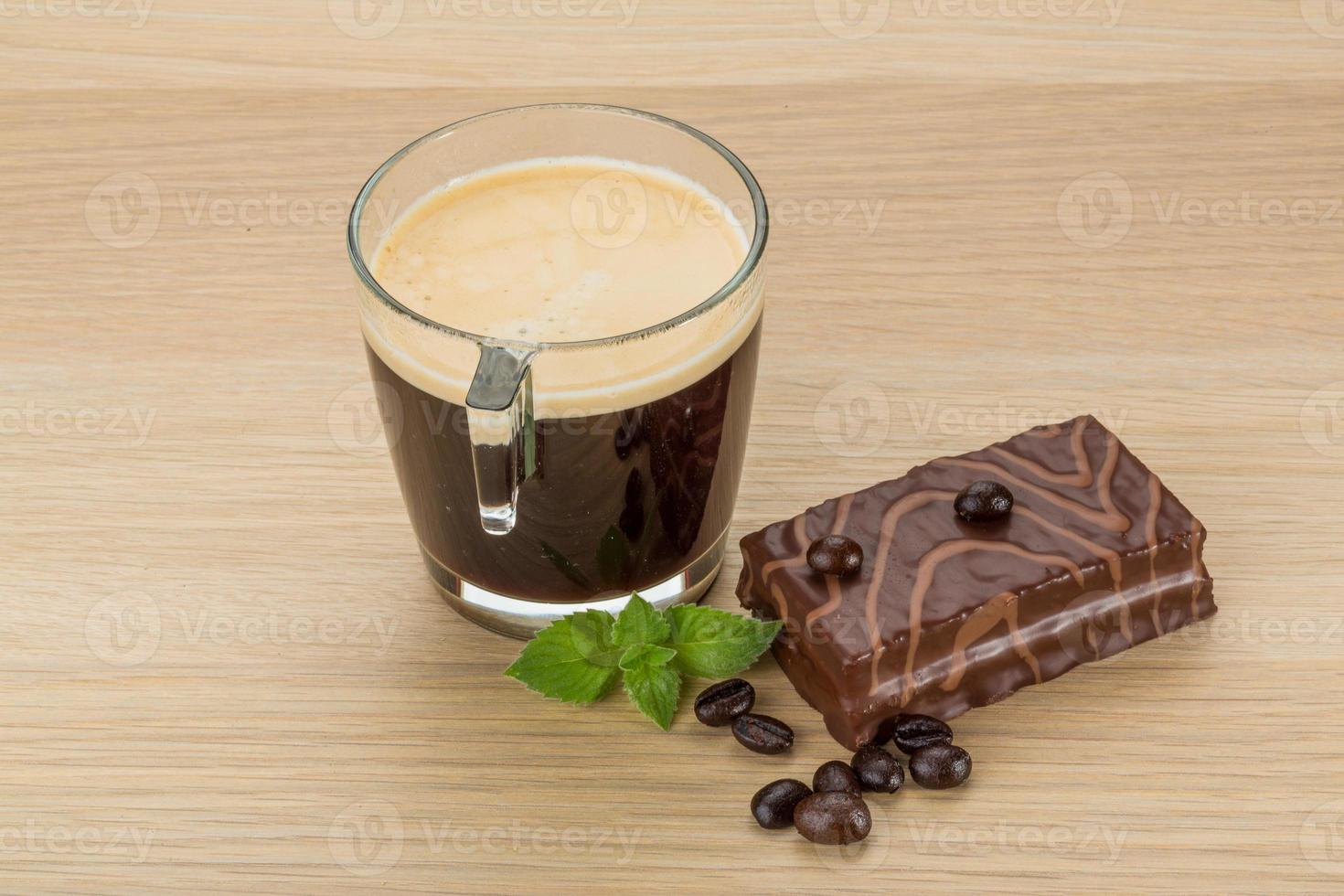 Coffe with cake on wooden background photo