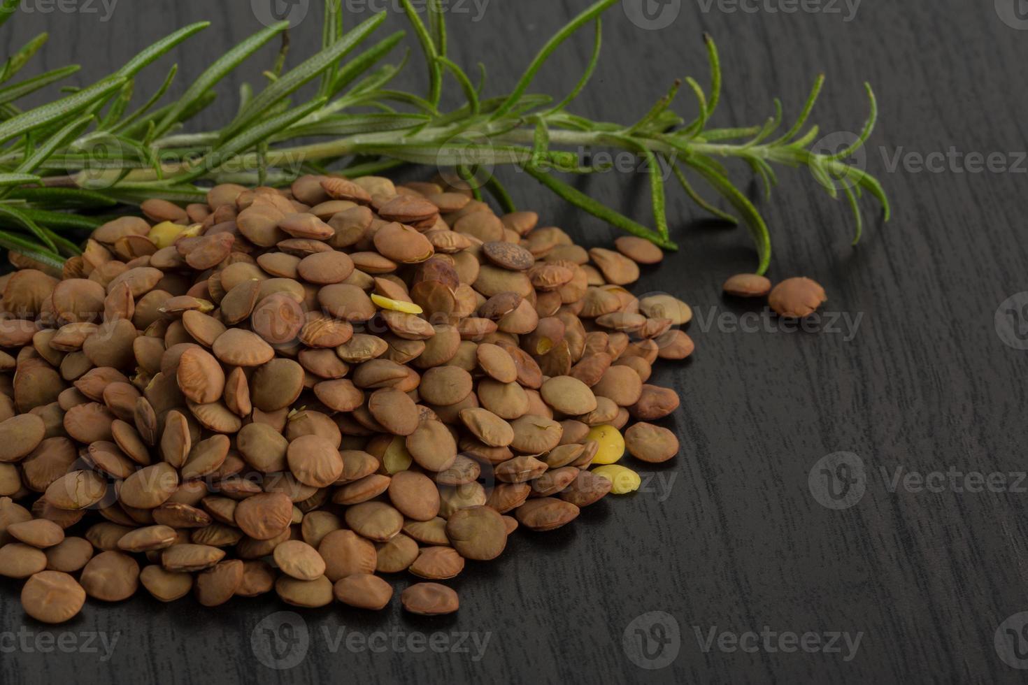 Raw lentils on wooden background photo