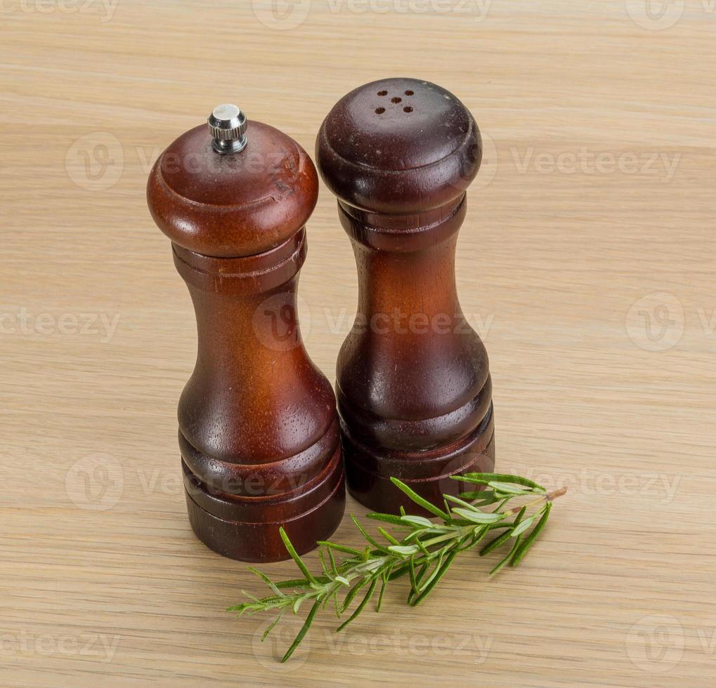 Pepper mill on wooden background photo
