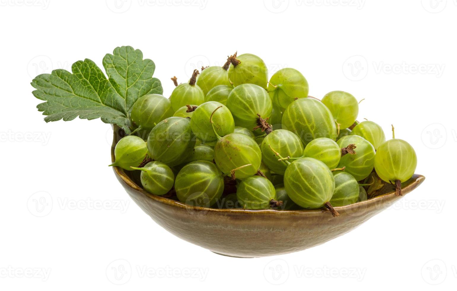 Gooseberries in a bowl on white background photo