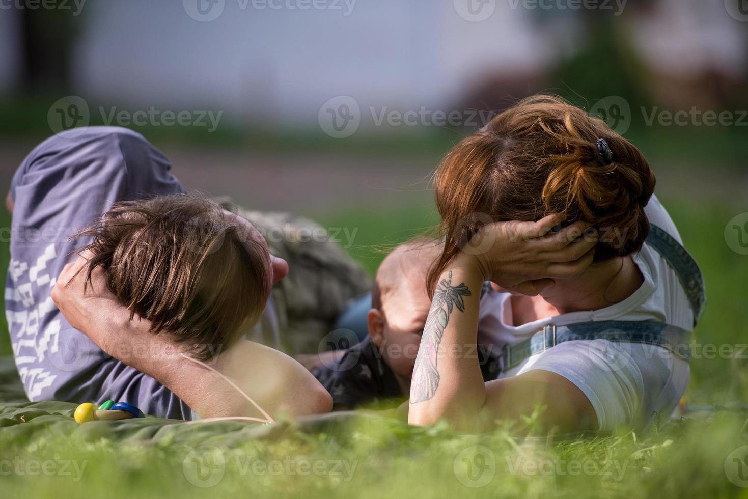 hipster family relaxing in park photo