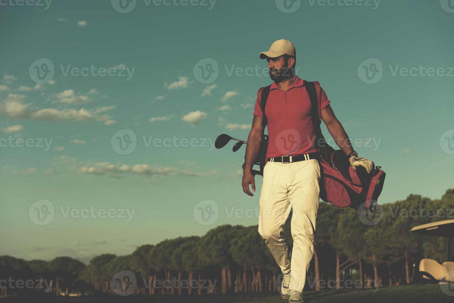 golfer  walking and carrying golf  bag photo