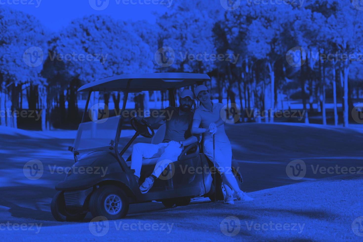 couple in buggy on golf course photo