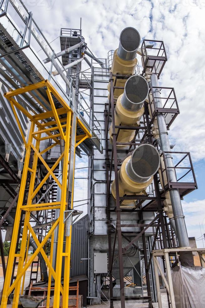 Modern Granary elevator. Silver silos on agro-processing and manufacturing plant for processing drying cleaning and storage of agricultural products, flour, cereals and grain. photo