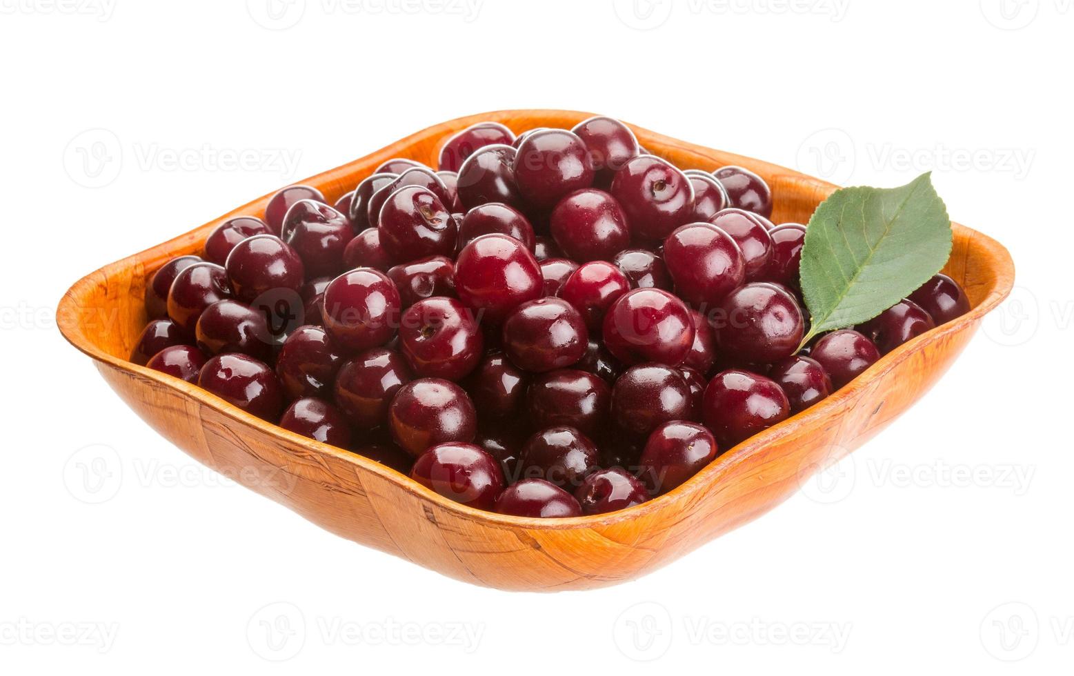 Cherry in the bowl on white background photo