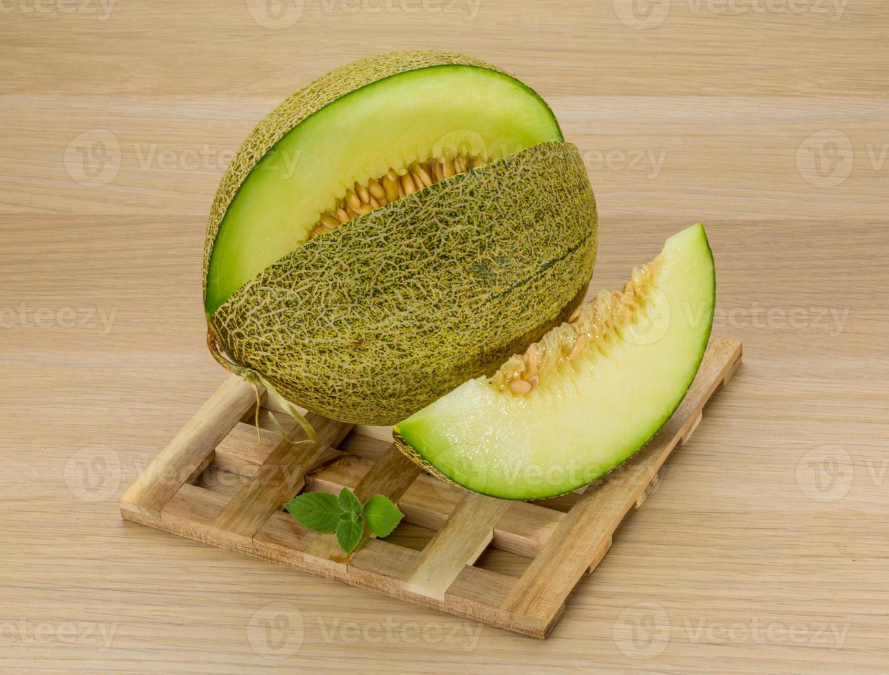 Melon on wooden background photo