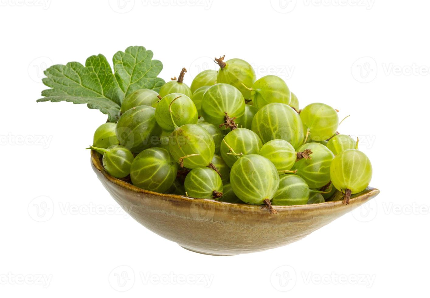 Gooseberries in a bowl on white background photo
