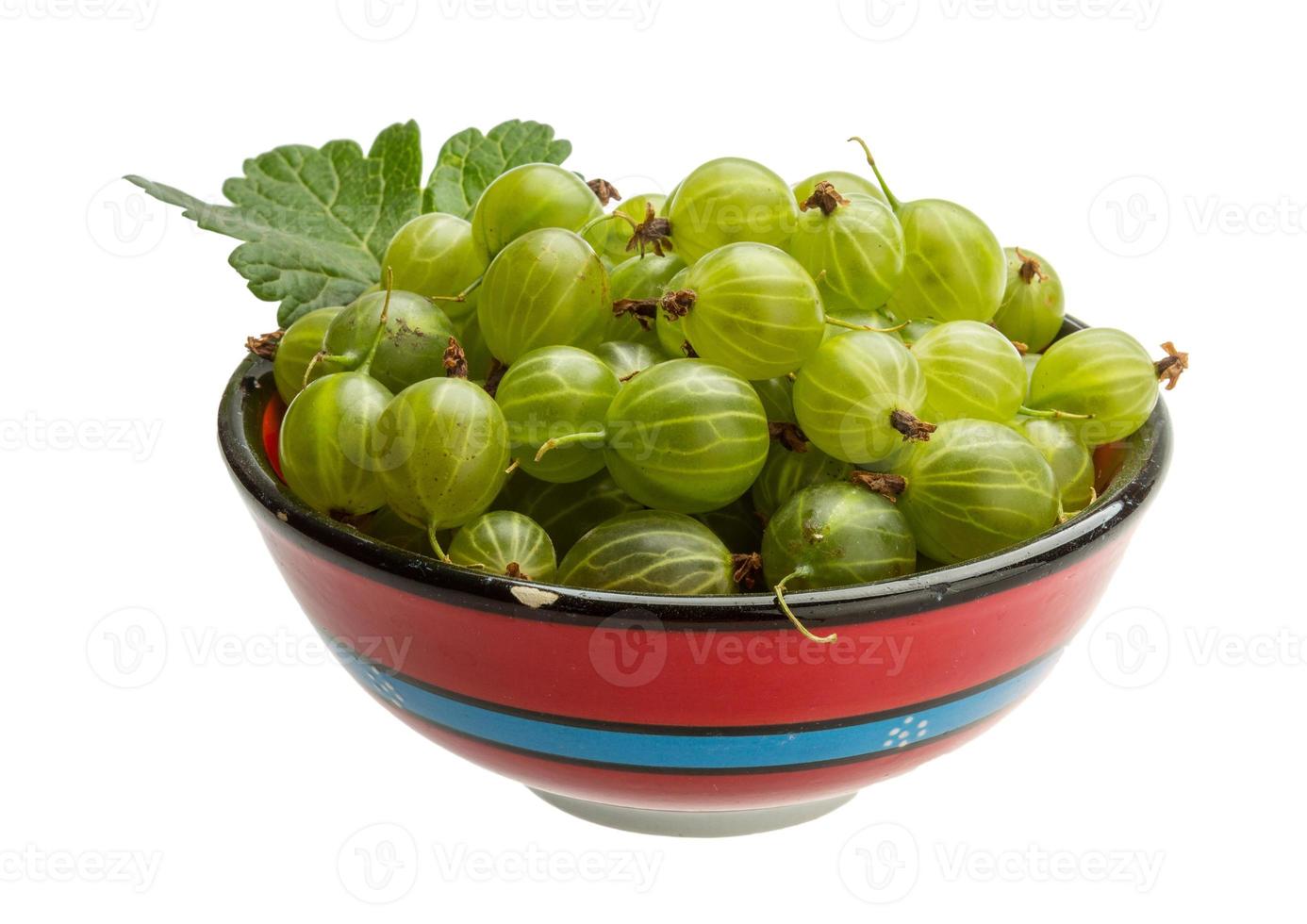 Gooseberry in a bowl on white background photo