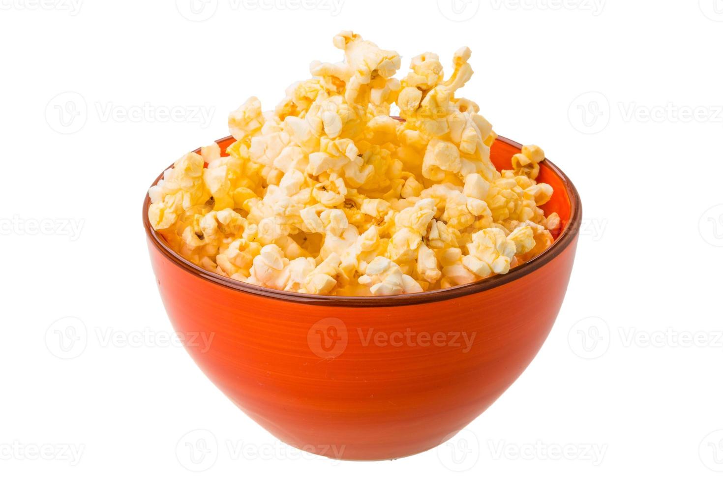 Popcorn in a bowl on white background photo