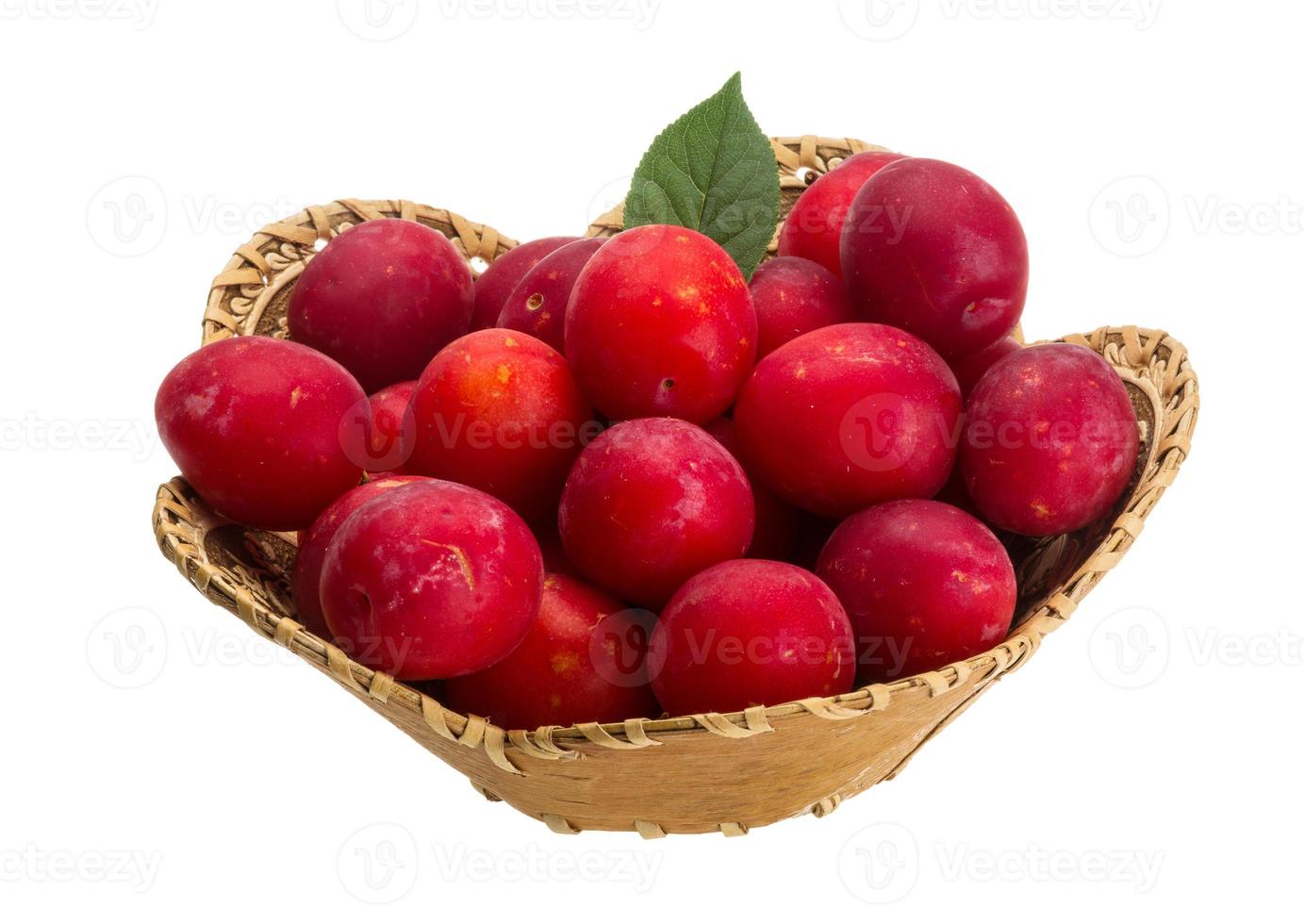 Damson plum in a basket on white background photo
