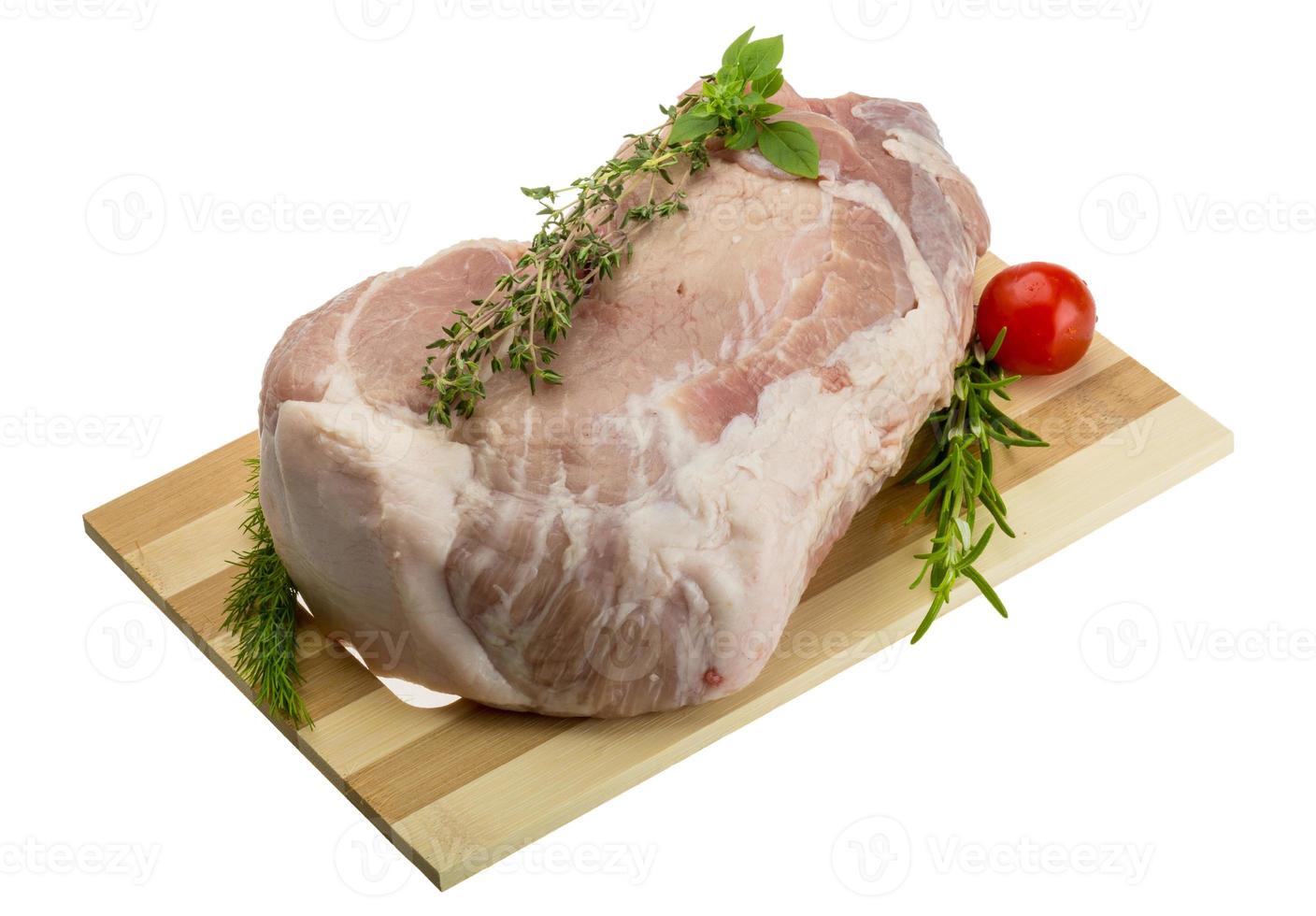 Raw pork meat on wooden plate and white background photo