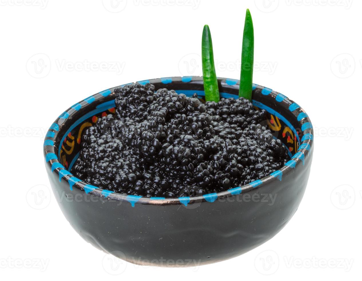 Black caviar in a bowl on white background photo