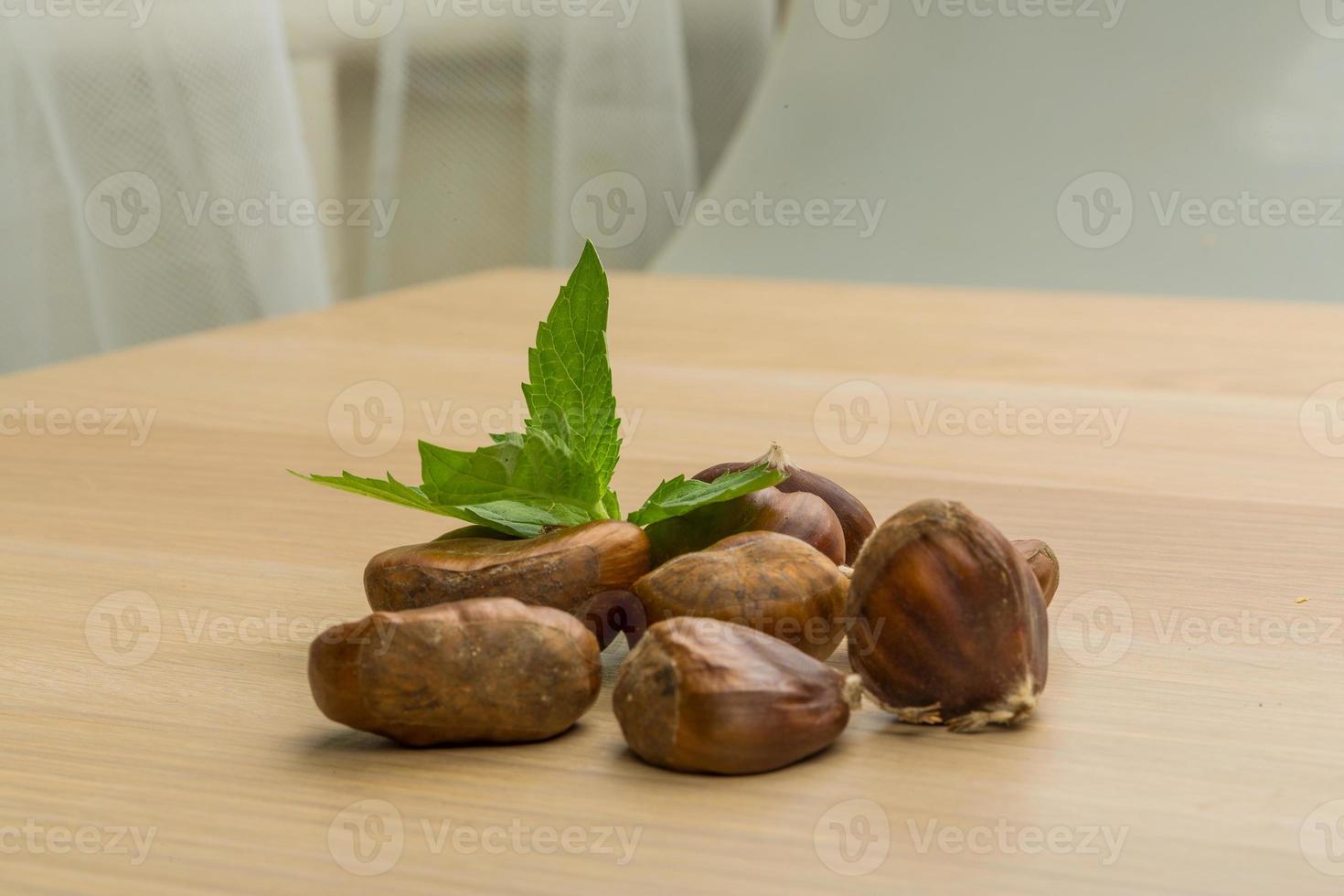 Chestnut on wooden background photo