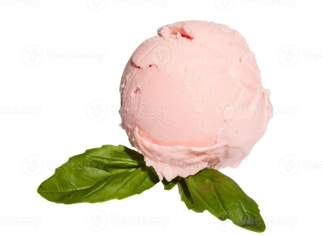 Scoop of strawberry ice cream from top on white background with mint photo