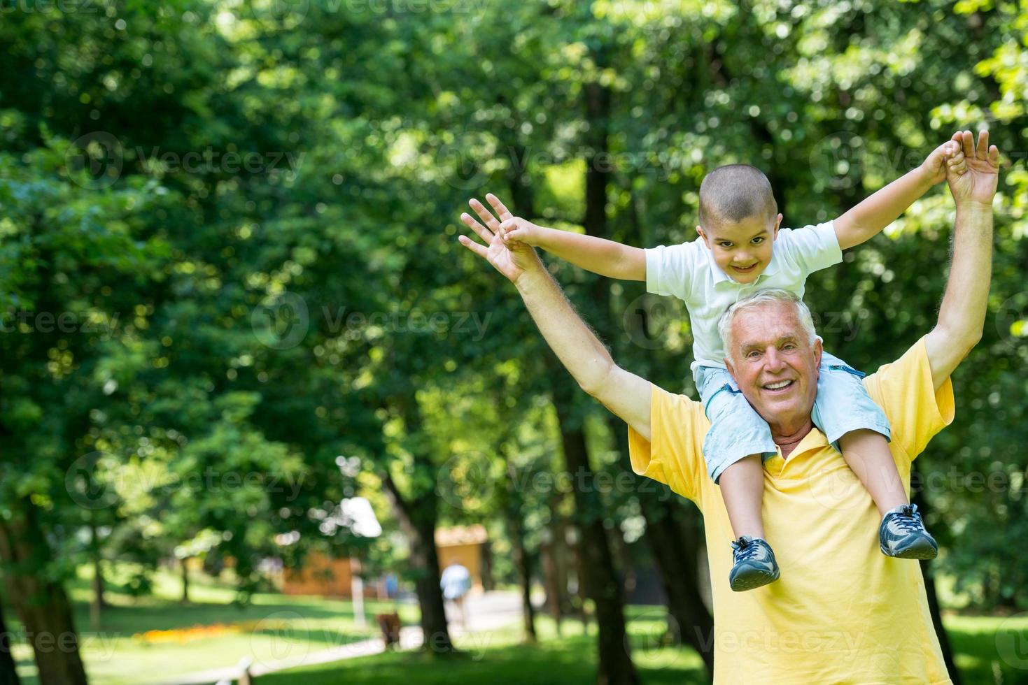 grandfather and child have fun  in park photo