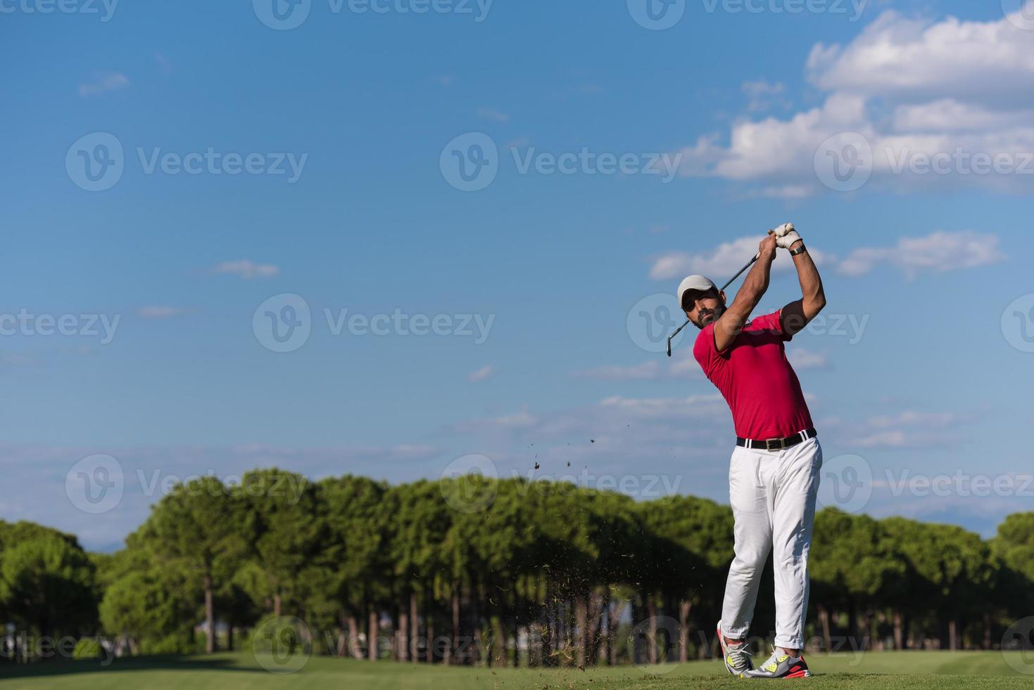 golf player hitting long shot photo