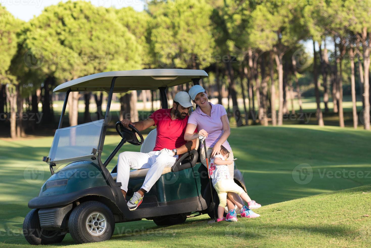 couple in buggy on golf course photo