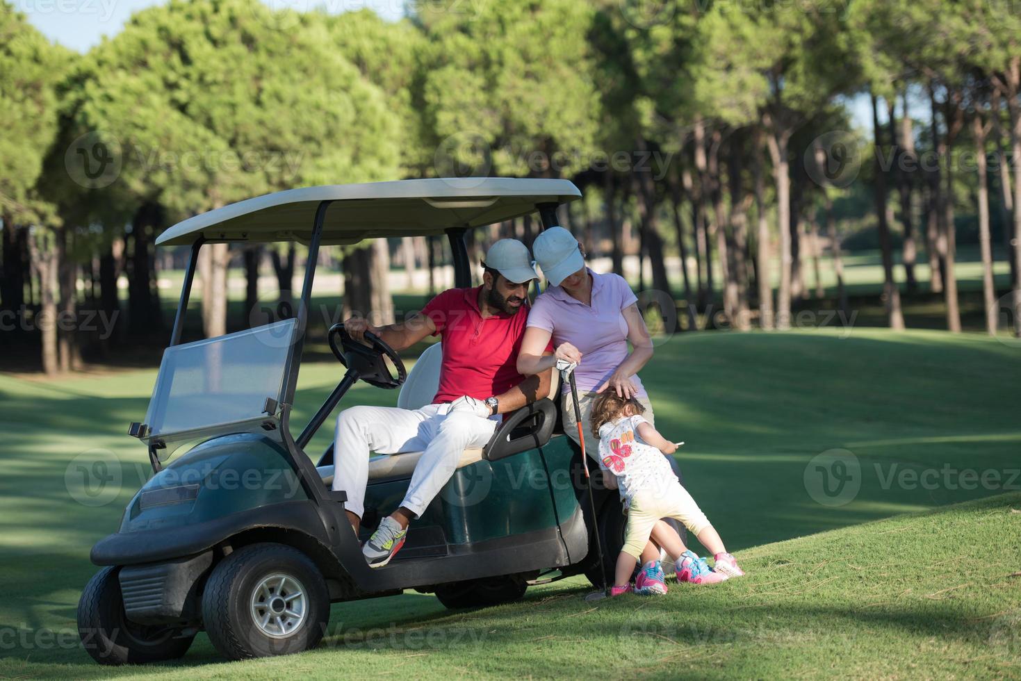 couple in buggy on golf course photo