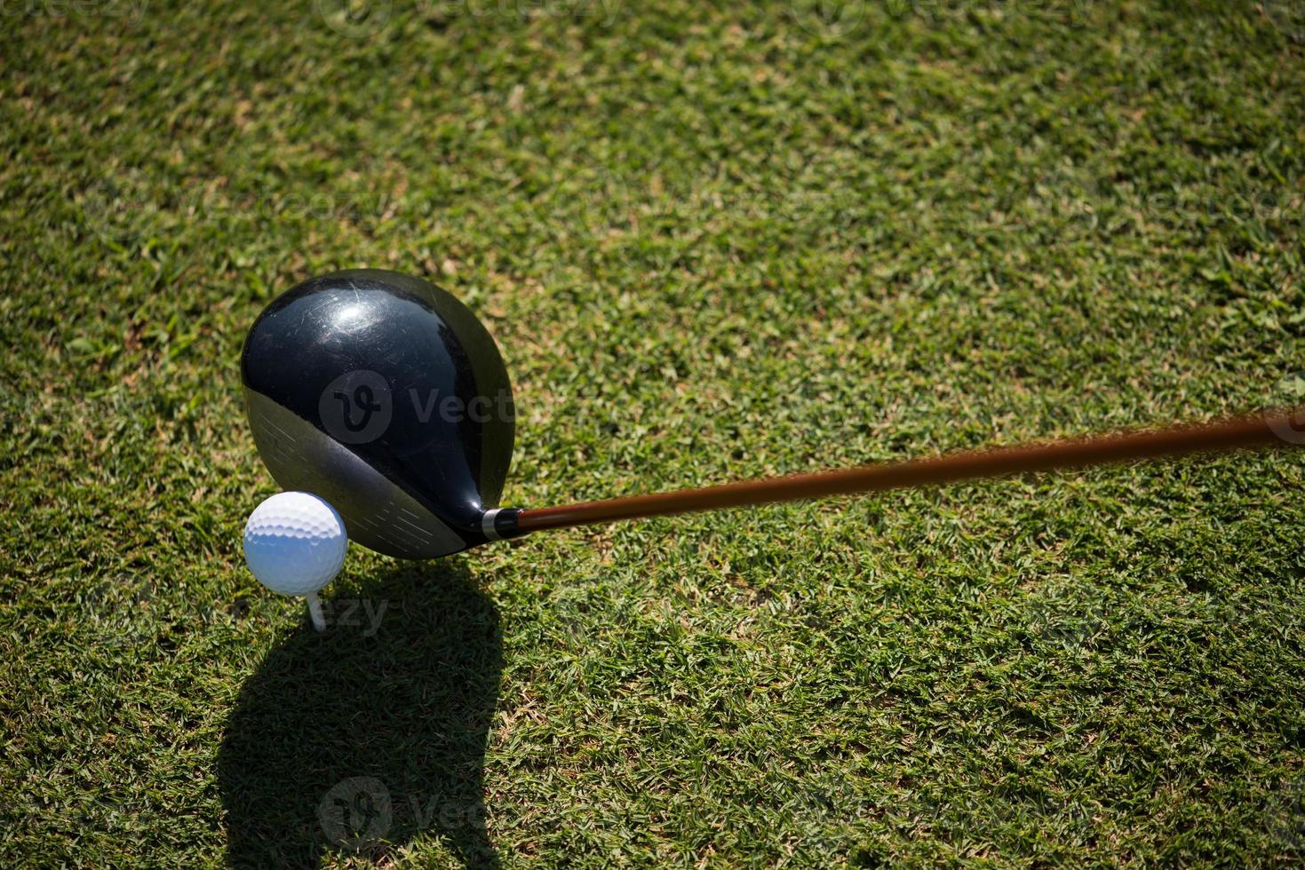 top view of golf club and ball in grass photo