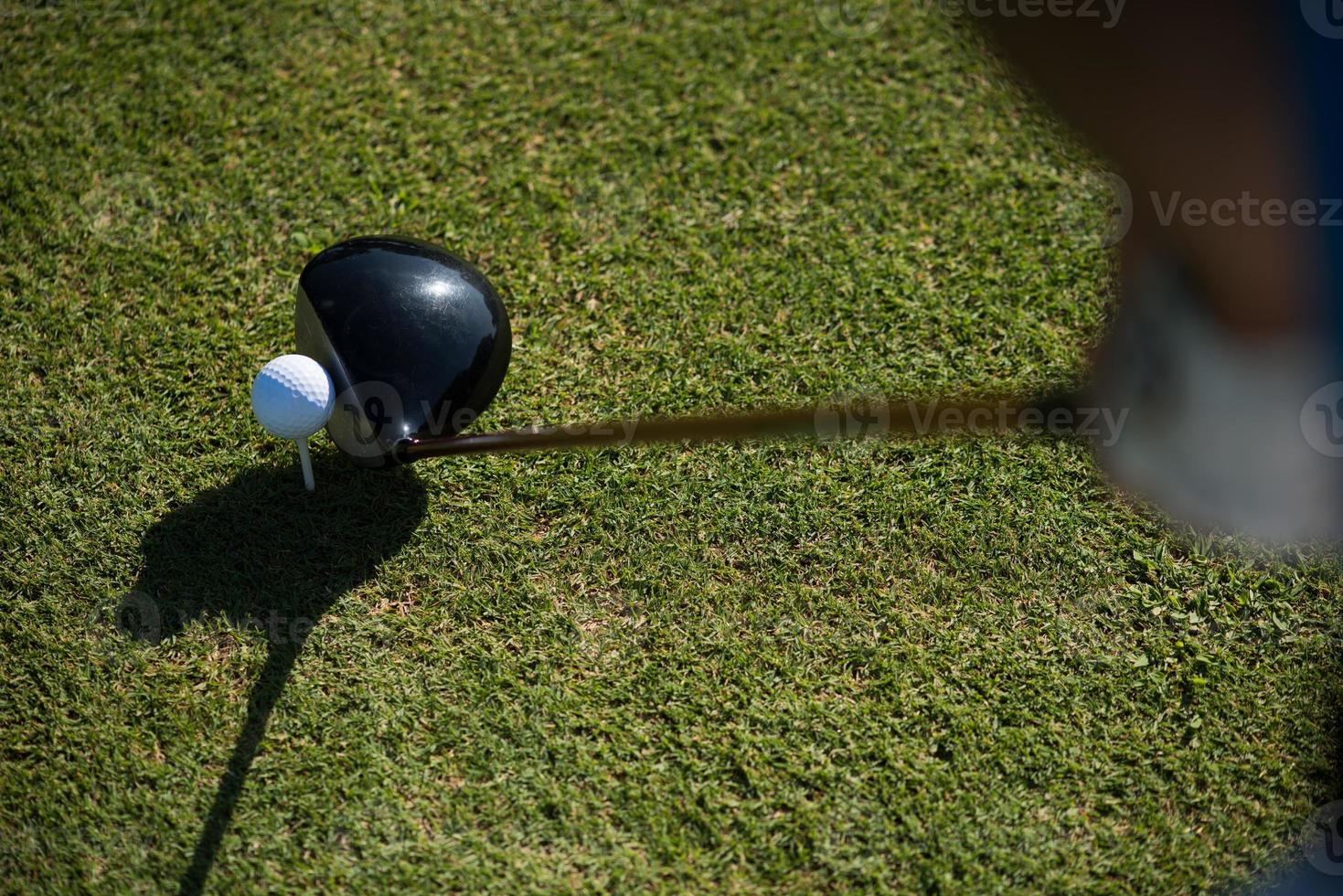 top view of golf club and ball in grass photo