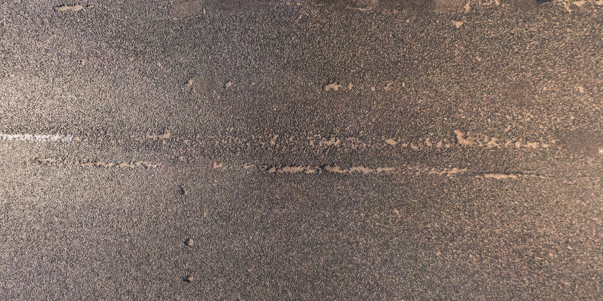 view from above on texture of old asphalt road photo