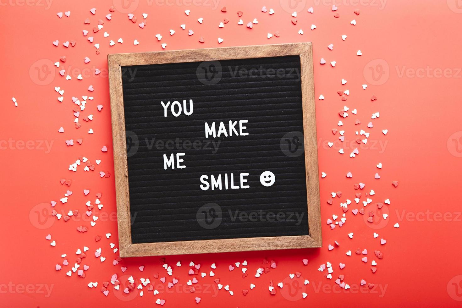 Letter board with hearts on red background. Top view. Background for Valentine's day photo