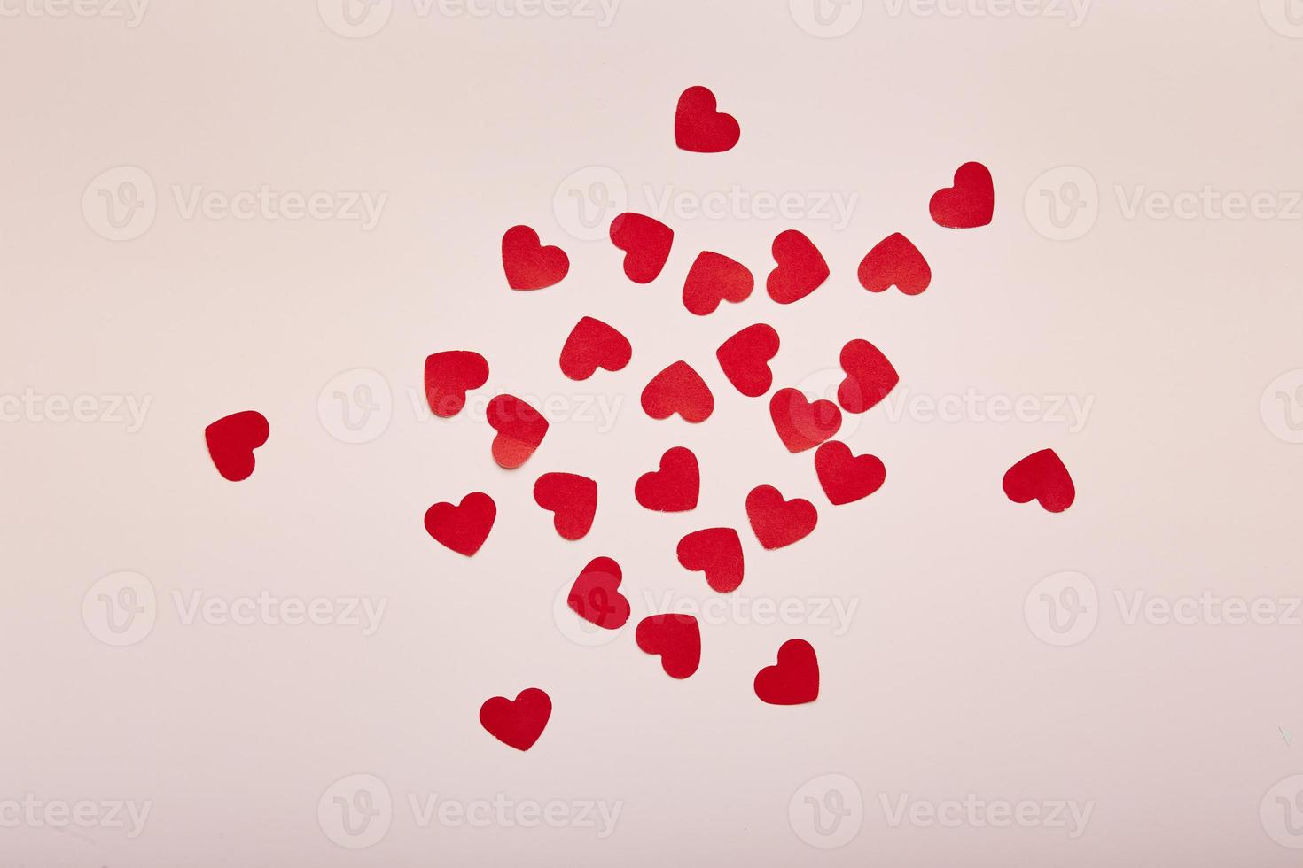Red paper hearts on pink background. Romantic background for Valentine's day photo