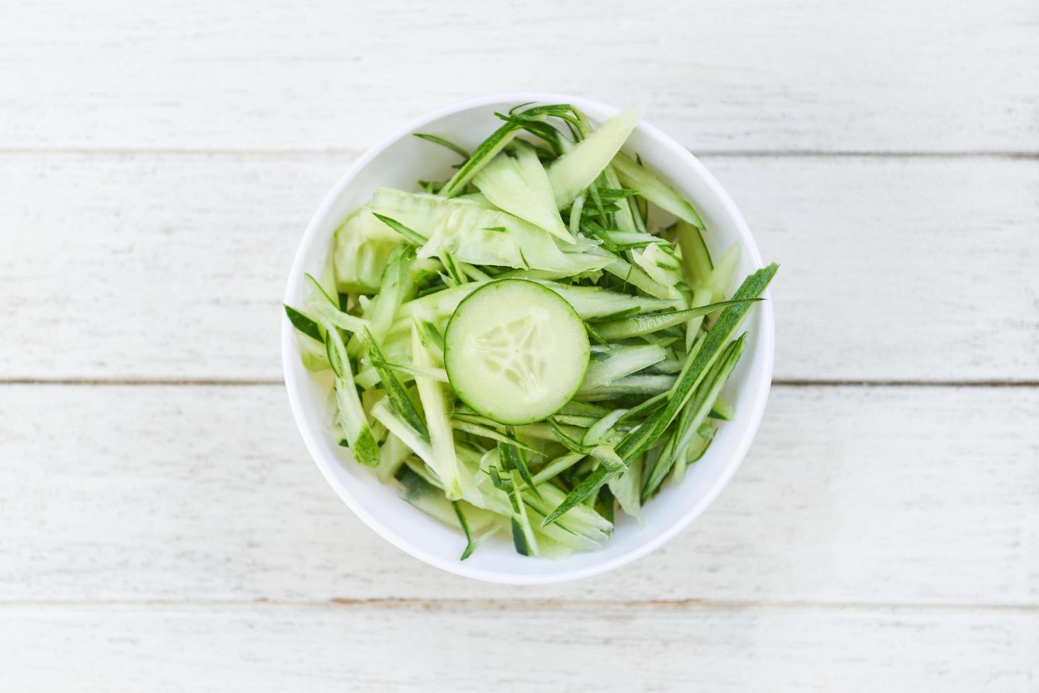 cucumber slice on white bowl , top view - shredded cucumber sliced for salad or cooking food photo