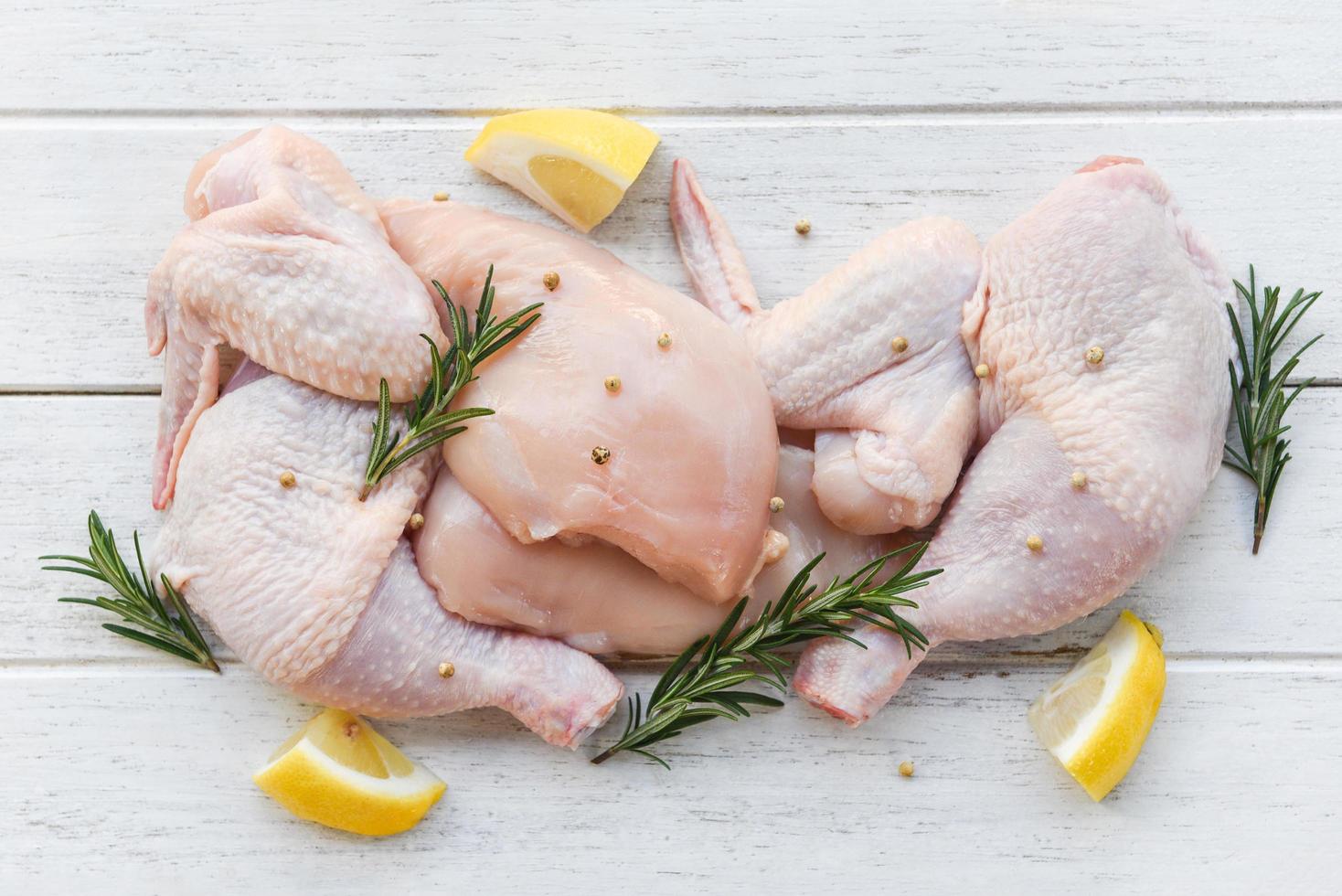 https://static.vecteezy.com/system/resources/previews/010/889/032/non_2x/breast-wings-and-legs-uncooked-chicken-meat-marinated-with-ingredients-for-cooking-fresh-raw-chicken-with-rosemary-lemon-herbs-and-spices-free-photo.JPG