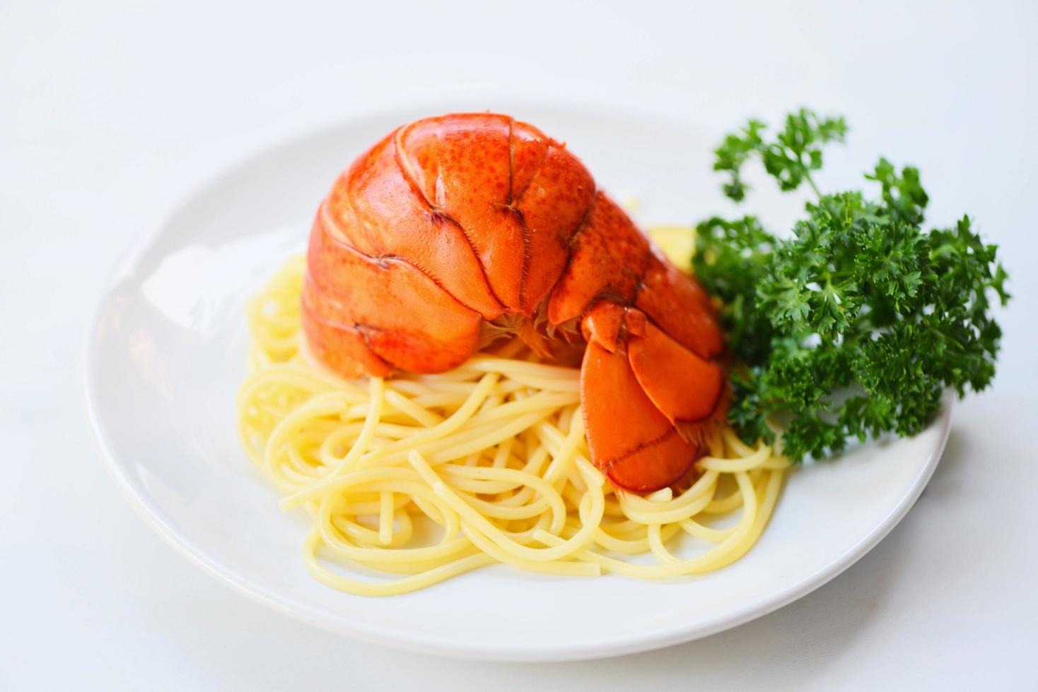 Boiled lobster tail cooked spaghetti seafood lobster food on a white plate photo