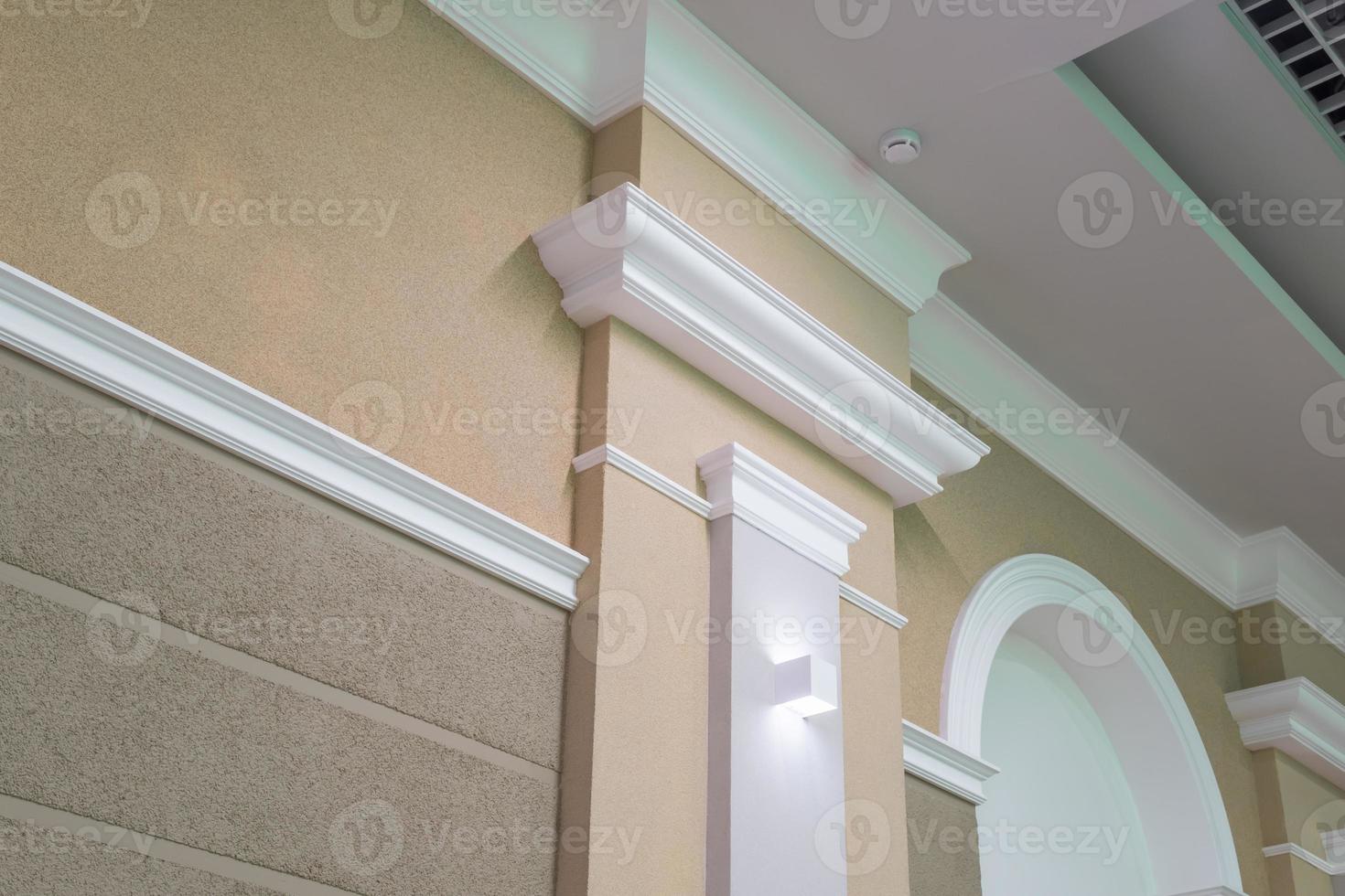 Detail of corner ceiling with intricate crown molding on column photo