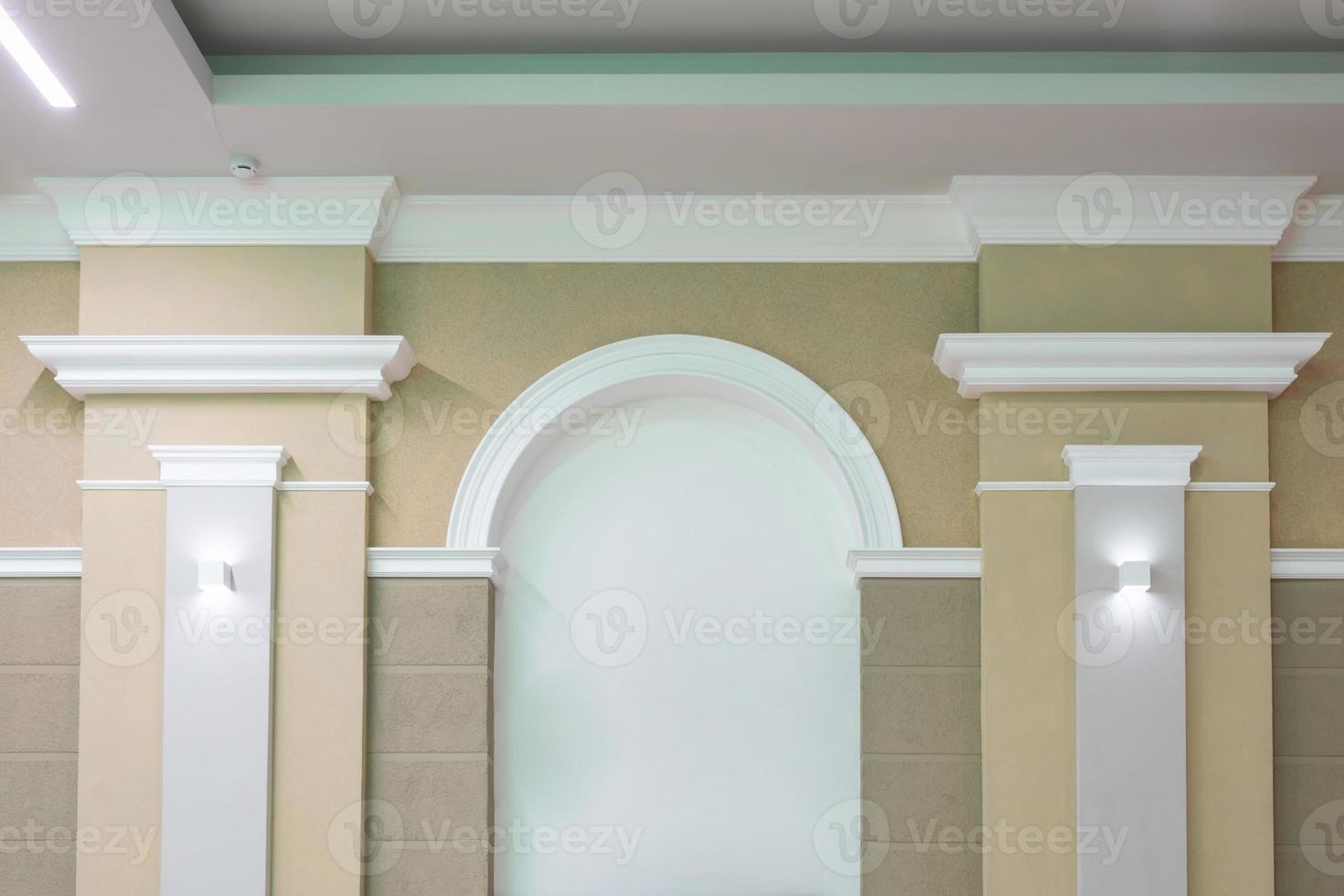Detail of corner ceiling with intricate crown molding on column with spot light photo