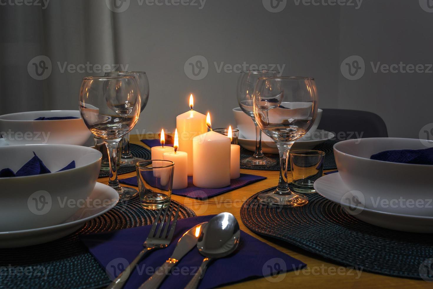 served table with cutlery and candles in interior of modern luxure guest room in studio apartments.  intimate atmosphere photo