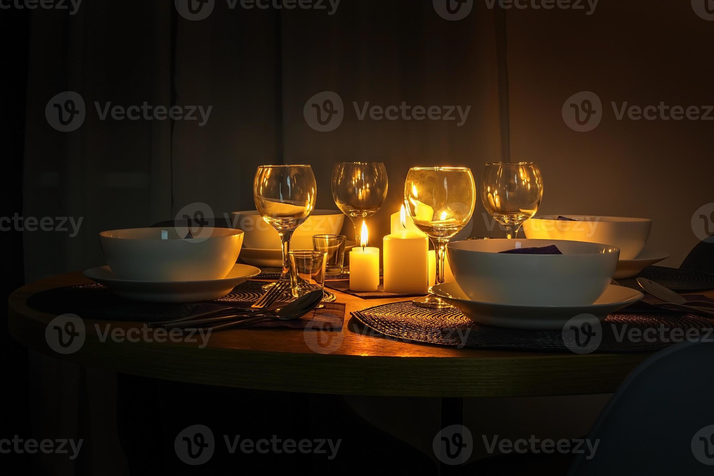 served table with cutlery and candles in interior of modern luxure