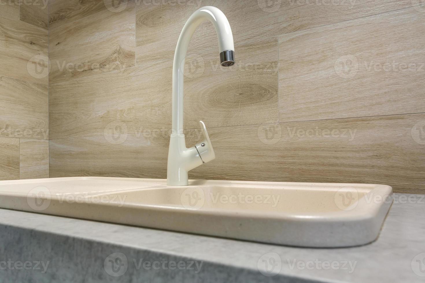 water tap sink with faucet in expensive loft bathroom or kitchen. photo