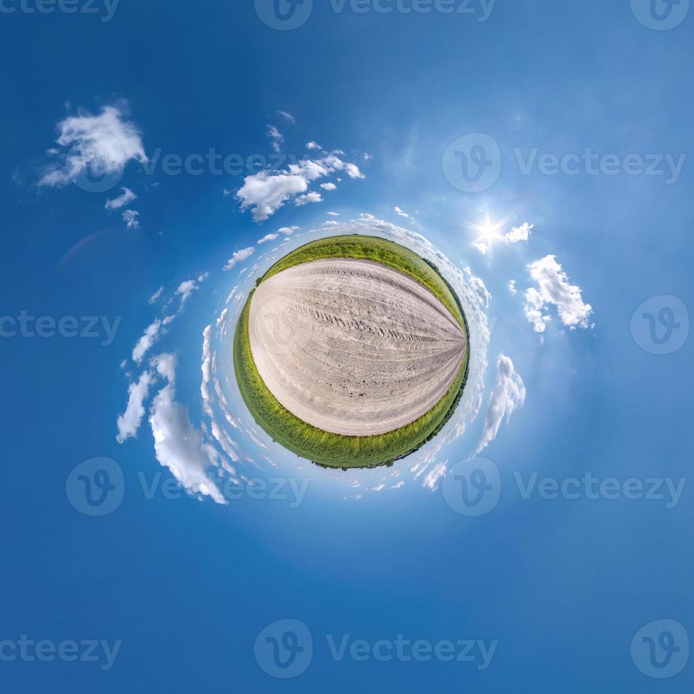 tiny planet transformation of spherical panorama 360 degrees. Spherical abstract aerial view in field with clear sky and awesome beautiful clouds. Curvature of space. photo