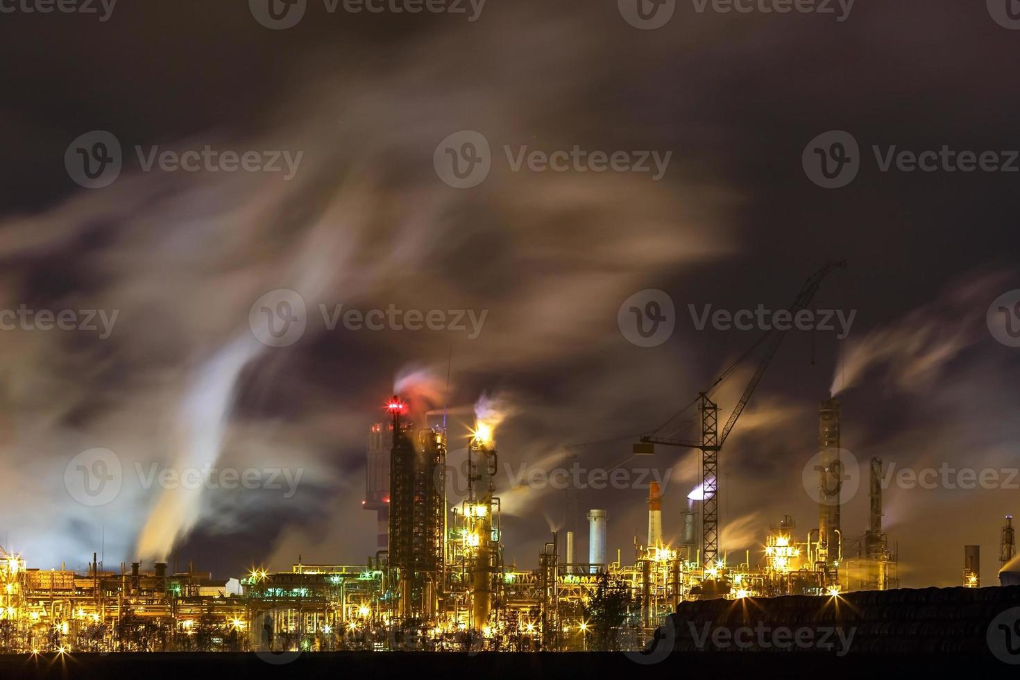 night industrial landscape environmental pollution waste of thermal power plant. Big pipes of chemical industry enterprise plant photo